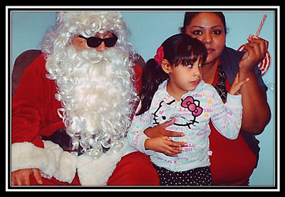 Santa posing with a Mother and Daughter